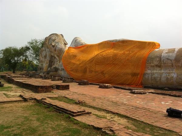 Large reclining Buddha draped in orange cloth among ancient bricks, Ayutthaya