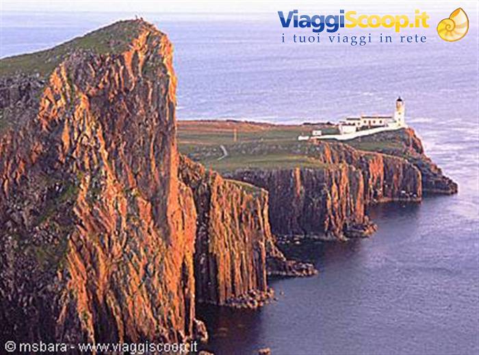 Neist Point lighthouse on basalt cliffs glowing in warm light, Skye