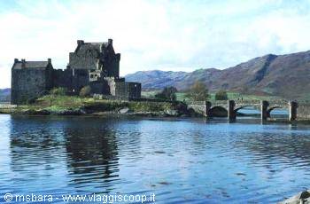 Eilean Donan stone castle with arched bridge over the loch
