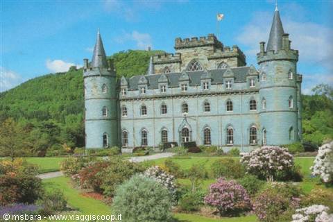 Inveraray Castle, grey stone with conical towers, among flowering gardens and green hills