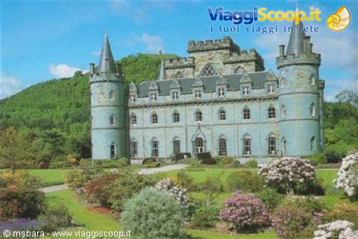 Inveraray Castle, grey stone with conical towers, among flowering gardens and green hills
