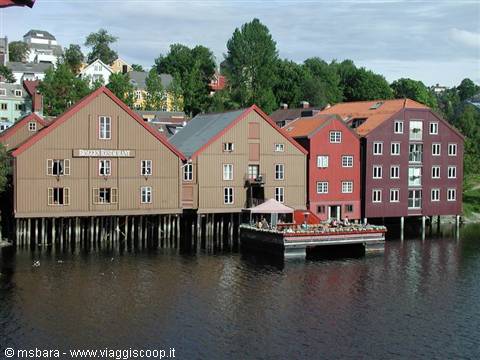 Old ochre and red wooden warehouses on stilts along the Nidelva, Trondheim