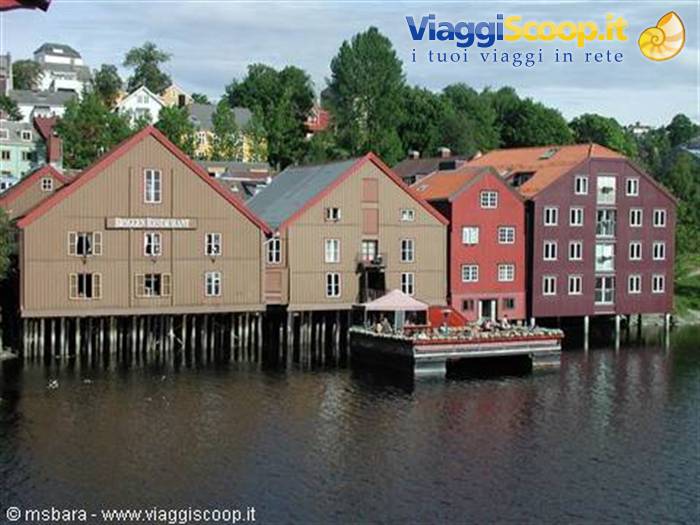 Old ochre and red wooden warehouses on stilts along the Nidelva, Trondheim