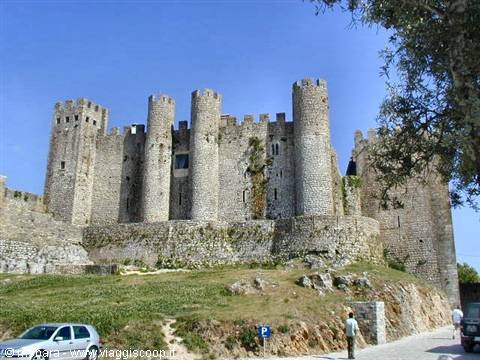 Óbidos castle, stone walls and towers under a blue sky