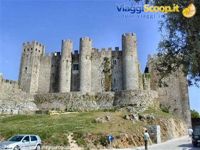 Óbidos castle, stone walls and towers under a blue sky