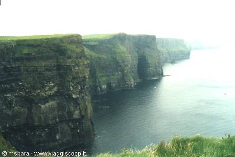 The Cliffs of Moher, sheer rock walls above the misty ocean