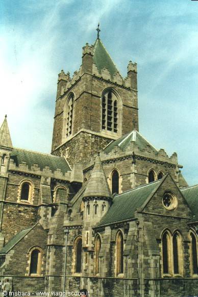 Christ Church Cathedral in Dublin, grey stone tower under clouds