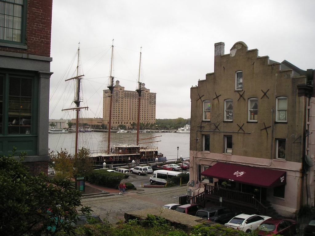 Savannah: tall ship moored on the river beside brick warehouses