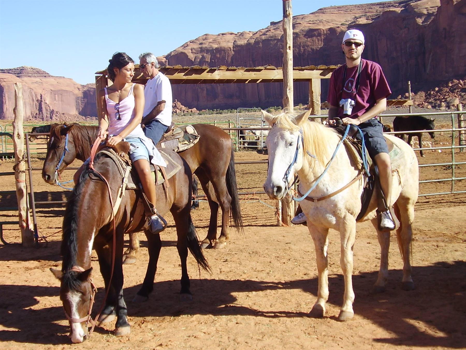 Horseback riders on red sand in Monument Valley
