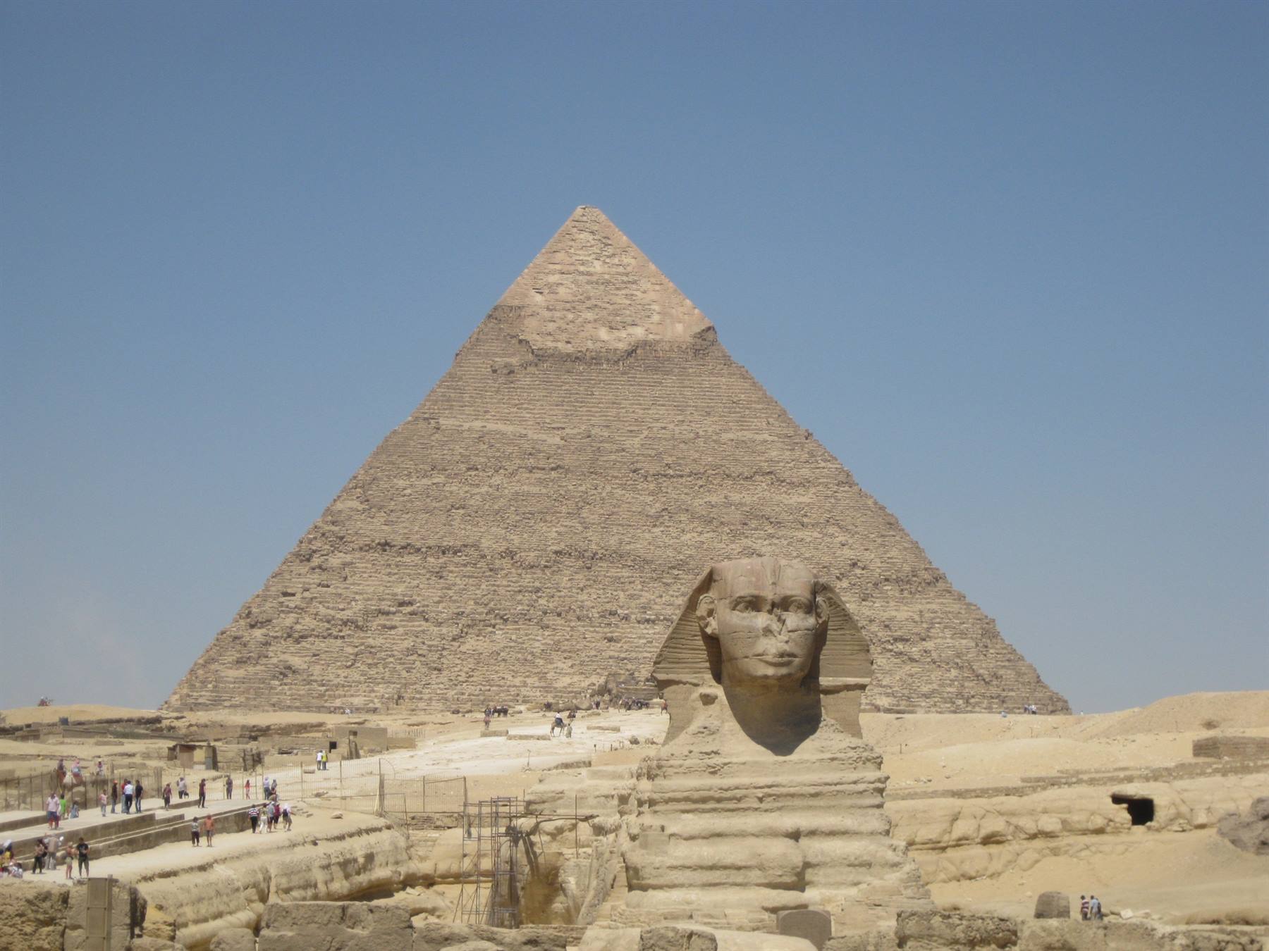 The Great Sphinx before the Cheops pyramid at Giza, tourists walking