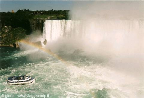 Niagara Falls, tourist boat in mist and rainbow near the falls