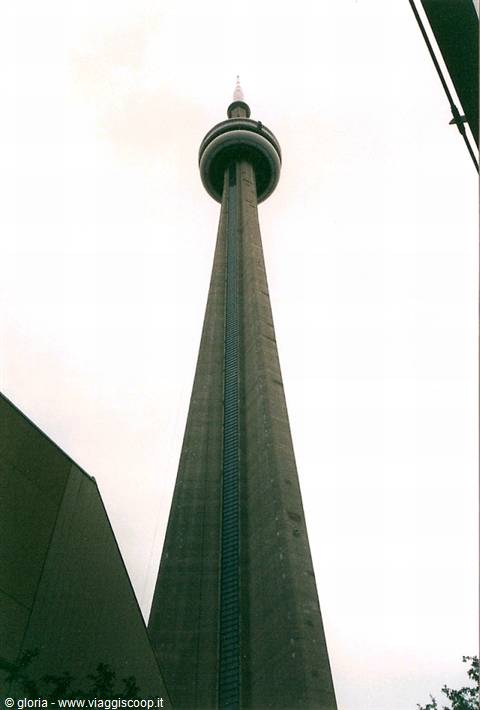 The CN Tower in Toronto seen from below against a white sky