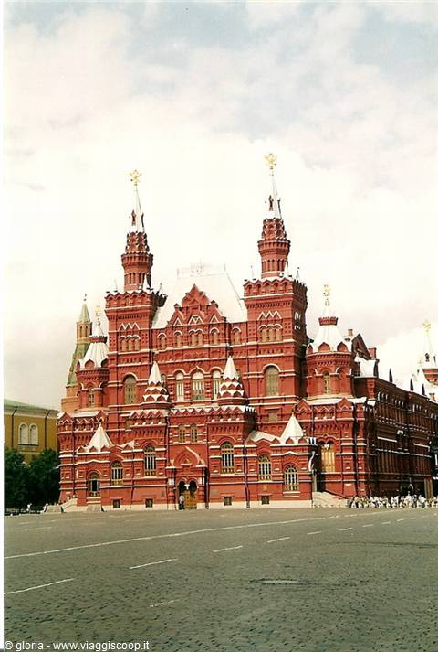 Red brick Historical Museum with snowy towers on Red Square