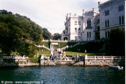 Tourists descend the steps from Miramare Castle down to the sea