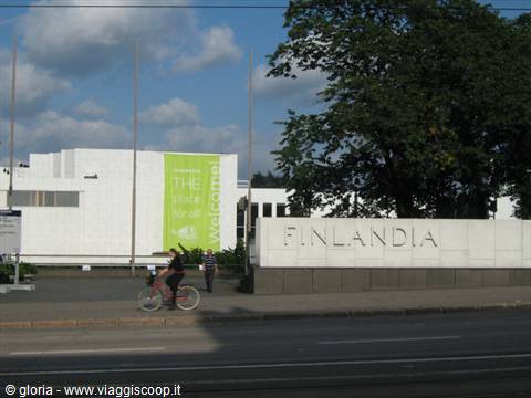 Cyclist passing the white Finlandia Hall wall by Alvar Aalto, Helsinki
