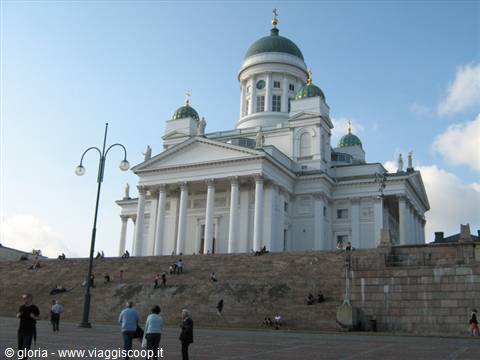 Helsinki Cathedral, white with green domes, tourists on granite steps