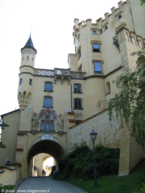 Hohenschwangau castle gateway with yellow walls, tower and stone lantern