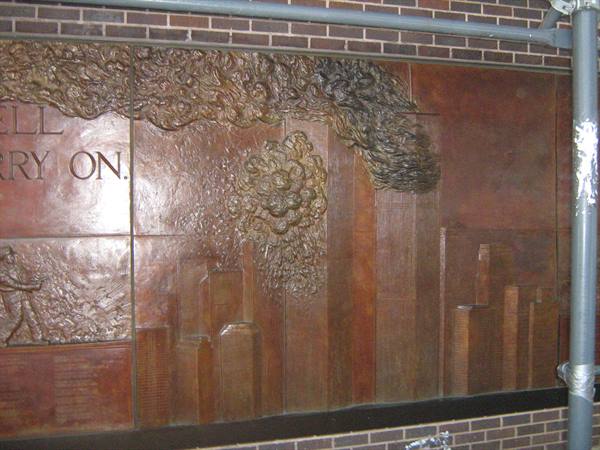 Bronze relief of the Twin Towers in smoke, subway memorial at Ground Zero