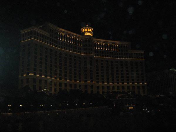 The Bellagio hotel lit at night with curved facade and golden sign