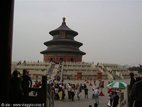 Tourists climb marble steps to the Temple of Heaven, Beijing, under grey sky