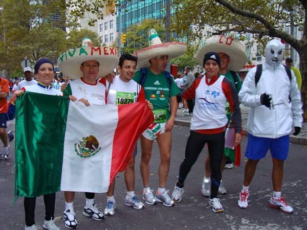 Runners in sombreros holding Mexican flag pose before the New York marathon