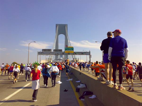 New York Marathon runners crossing the Verrazzano-Narrows Bridge under clear sky