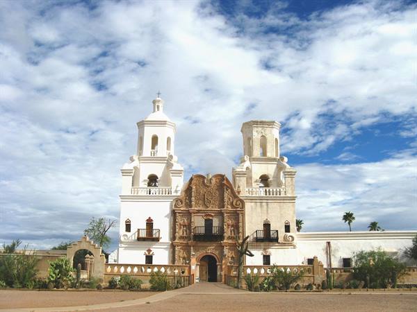 Missione San Xavier del Bac, facciata bianca tra cactus e nuvole