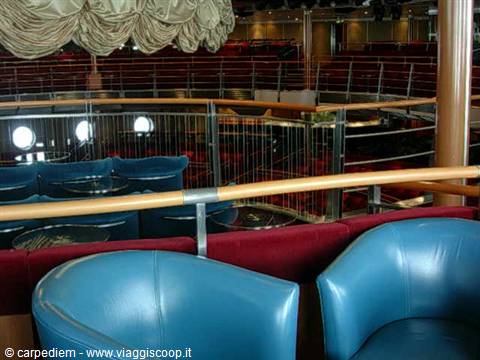Blue leather armchairs in the theater lounge of a cruise ship