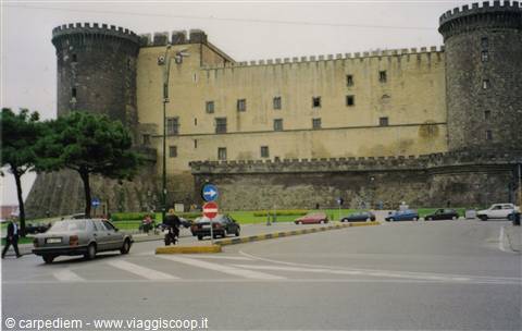 Castel Nuovo in Naples, crenellated towers above the busy street