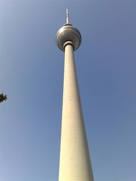 Berlin TV Tower seen from below against a clear blue sky