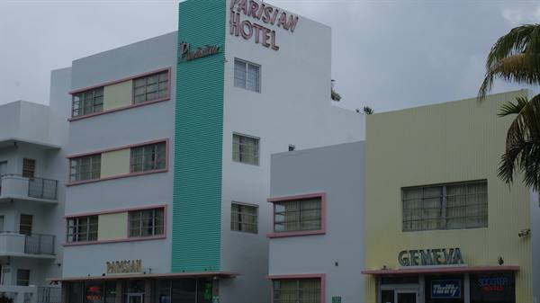 Art Deco facade of the Parisian Hotel with green band, beside the Geneva Hotel