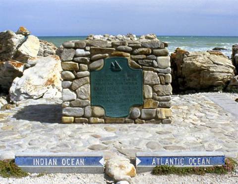 Stone monument with green plaque between Indian and Atlantic Ocean signs