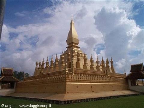 Pha That Luang golden stupa in Vientiane, under white clouds and blue sky