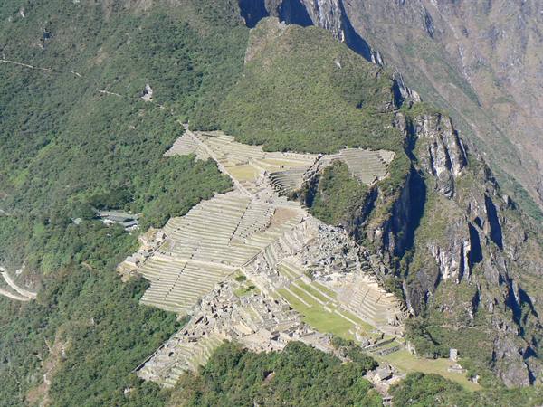 Stone ruins and terraces of Machu Picchu seen from above in daylight