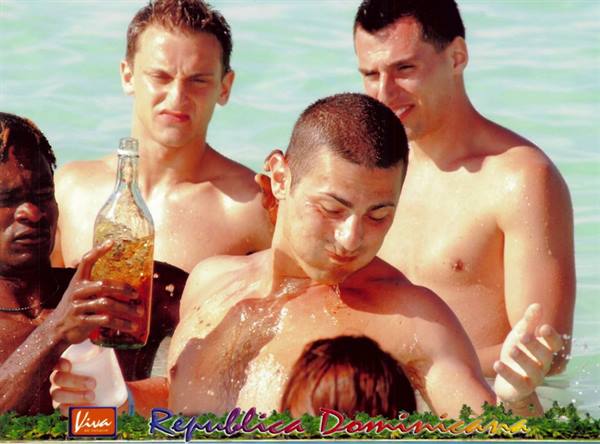 Guys joking in the sea with a bottle, Dominican Republic