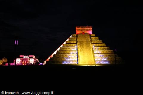 Chichén Itzá pyramid illuminated at night with colorful lights