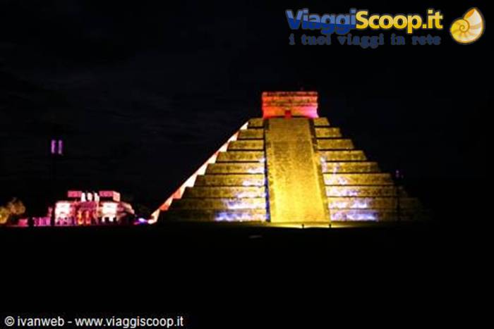 Chichén Itzá pyramid illuminated at night with colorful lights