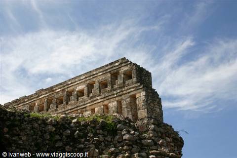 Mayan stone ruins at Uxmal under blue sky with clouds