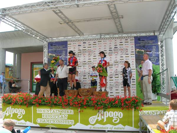 Podium award ceremony at Alpago mountain bike European championships, red flowers