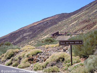 Sign reading Base del Teide 2250 m among shrubs and arid volcanic slopes