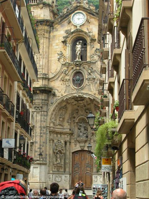 Baroque facade of Santa María basilica in Donostia, tourists among buildings