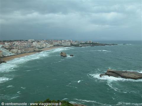 Waves crashing on rocks and buildings along the beach, Biarritz