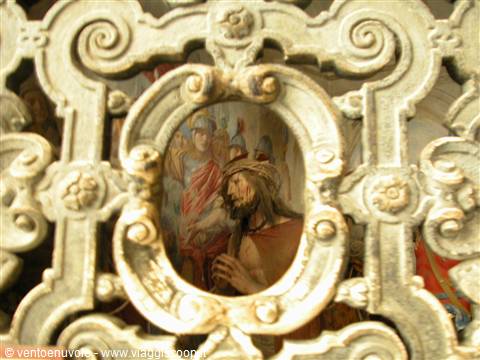 Fresco of Christ crowned with thorns inside carved baroque stone frame