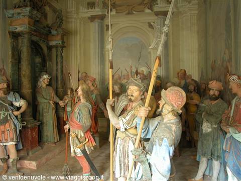 Painted wooden statues at the Sacro Monte, halberd soldiers among frescoed architecture