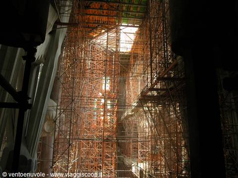 Orange scaffolding inside Barcelona's Sagrada Familia, light through columns