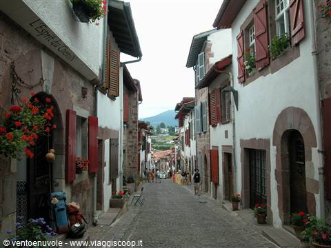 Cobbled uphill street between whitewashed houses with red shutters, Saint-Jean-Pied-de-Port