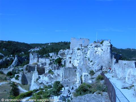 Ruins of Les Baux-de-Provence castle atop the rock, blue night light