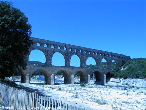 The Pont du Gard, Roman stone aqueduct, crosses the river under bright sun