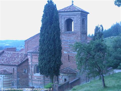 Brick bell tower and cypress beside Vezzolano church