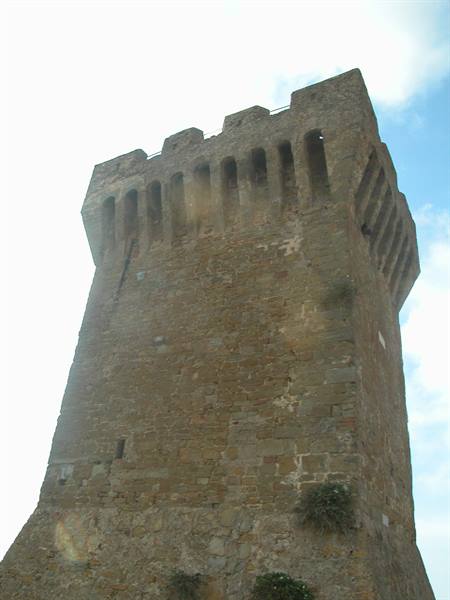 Medieval stone tower with machicolations in Populonia against the sky